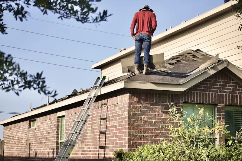 Professional roofer working on a residential roof in Watertown
